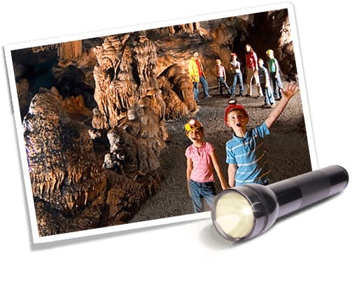 image of people in cave with flashlight