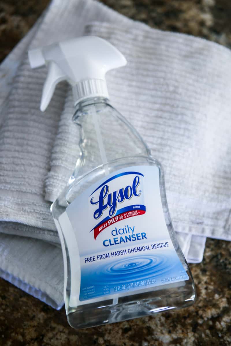 lysol spray and white rags on granite counter