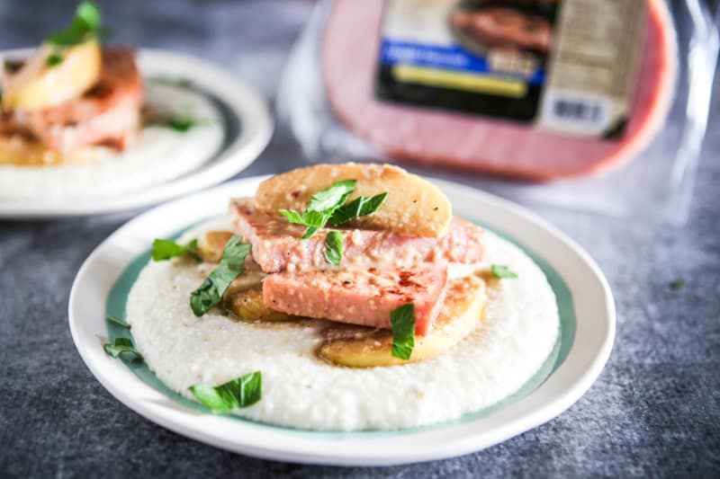 single plate of ham and grits in focus
